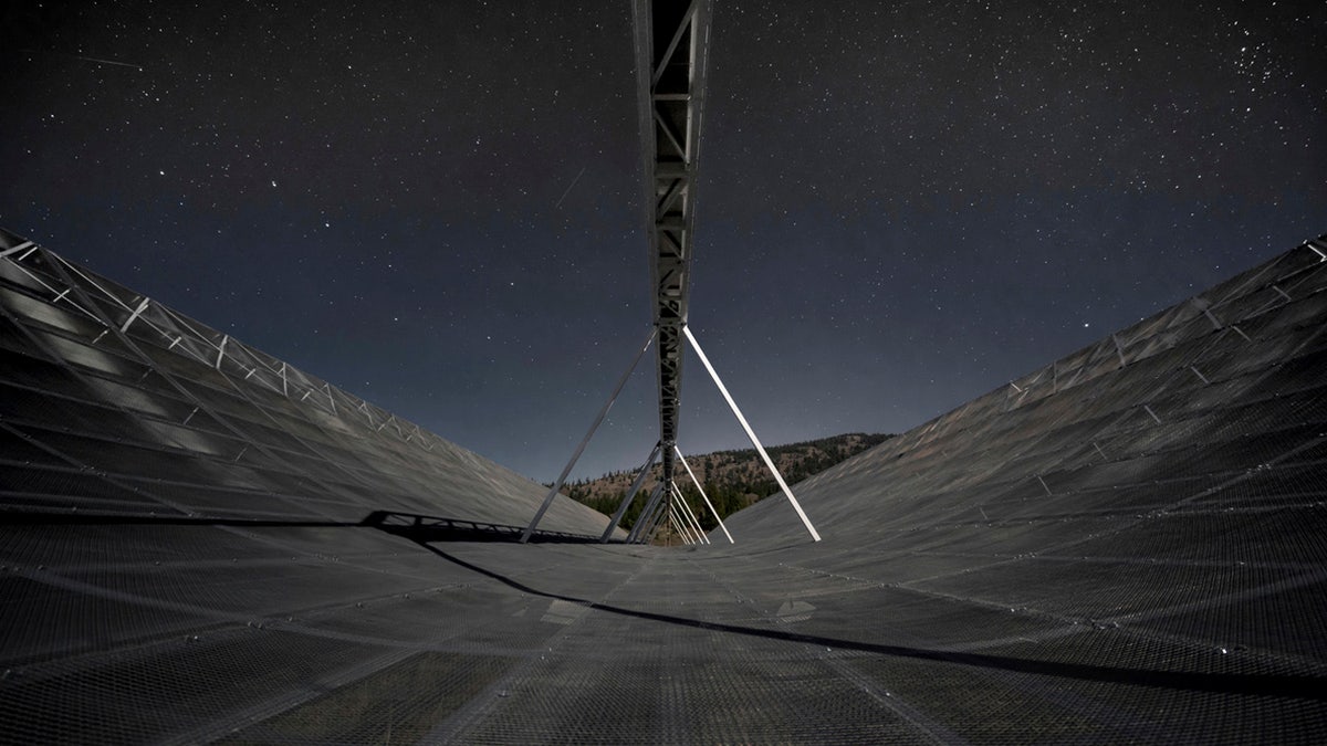 This November 2016 photo provided by the Canadian Hydrogen Intensity Mapping Experiment collaboration shows the CHIME radio telescope at the Dominion Radio Astrophysical Observatory in Kaleden, British Columbia, Canada.