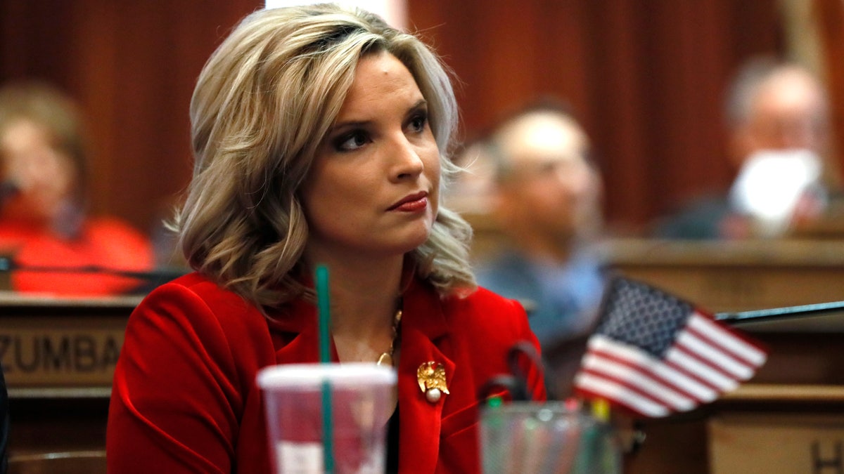 Ashley Hinson, a multitasking, minivan-driving mom, flipped a blue seat red in Iowa by campaigning on kitchen table issues and pledging to be a taxpayer advocate in Congress. (AP Photo/Charlie Neibergall, File)