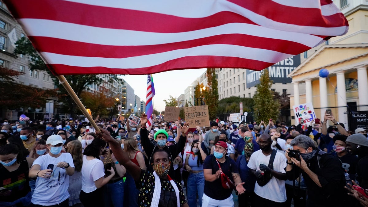 People gather in Black Lives Matter Plaza on Nov. 7, 2020, to celebrate President-elect Joe Biden's win over President Donald Trump to become the 46th president of the United States. (AP Photo/Alex Brandon, File)