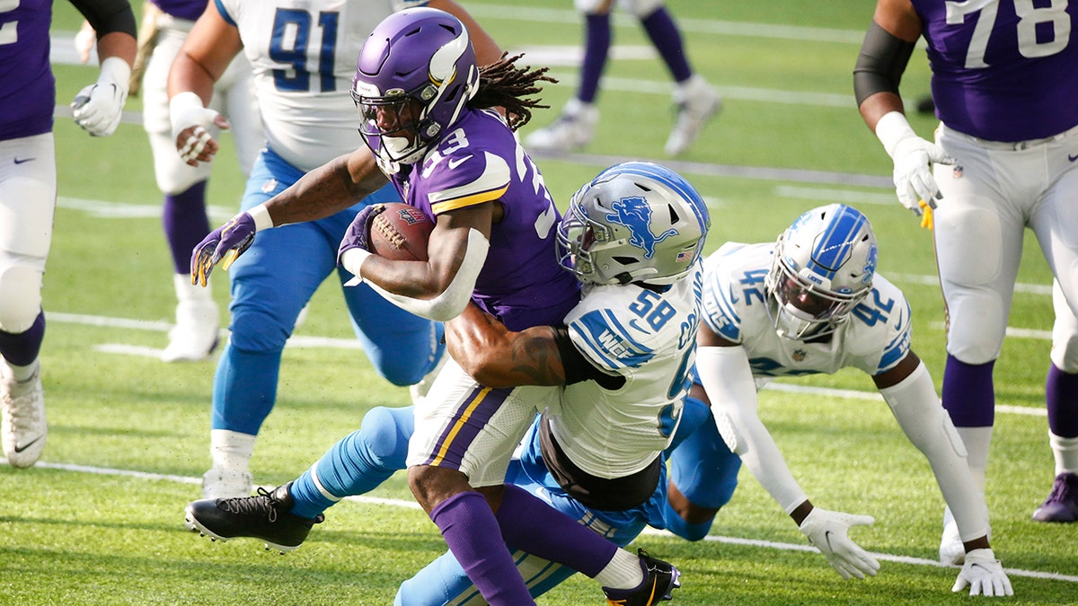 Minnesota Vikings running back Dalvin Cook (33) is tackled by Detroit Lions linebacker Jamie Collins Sr. (58) during the first half of an NFL football game, Sunday, Nov. 8, 2020, in Minneapolis. (AP Photo/Bruce Kluckhohn)