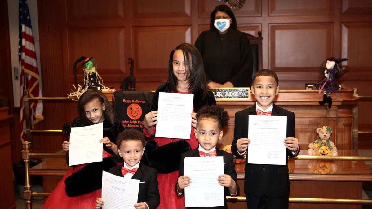 Robert Carter adopted Marionna,10 , Robert Jr., 9, Makayla, 8, Giovanni, 5, and Kiontae, 4, on Oct. 30. (SWNS)