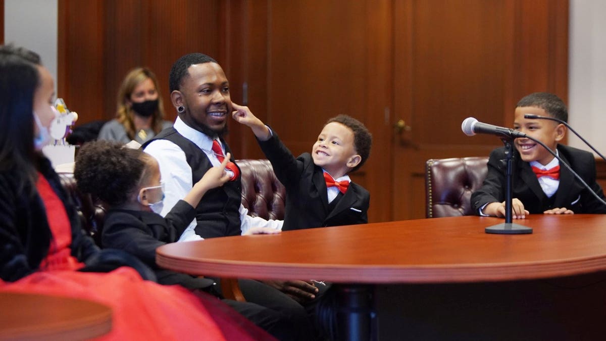 Robert Carter adopted five siblings because he didn't want them to be separated. (SWNS)