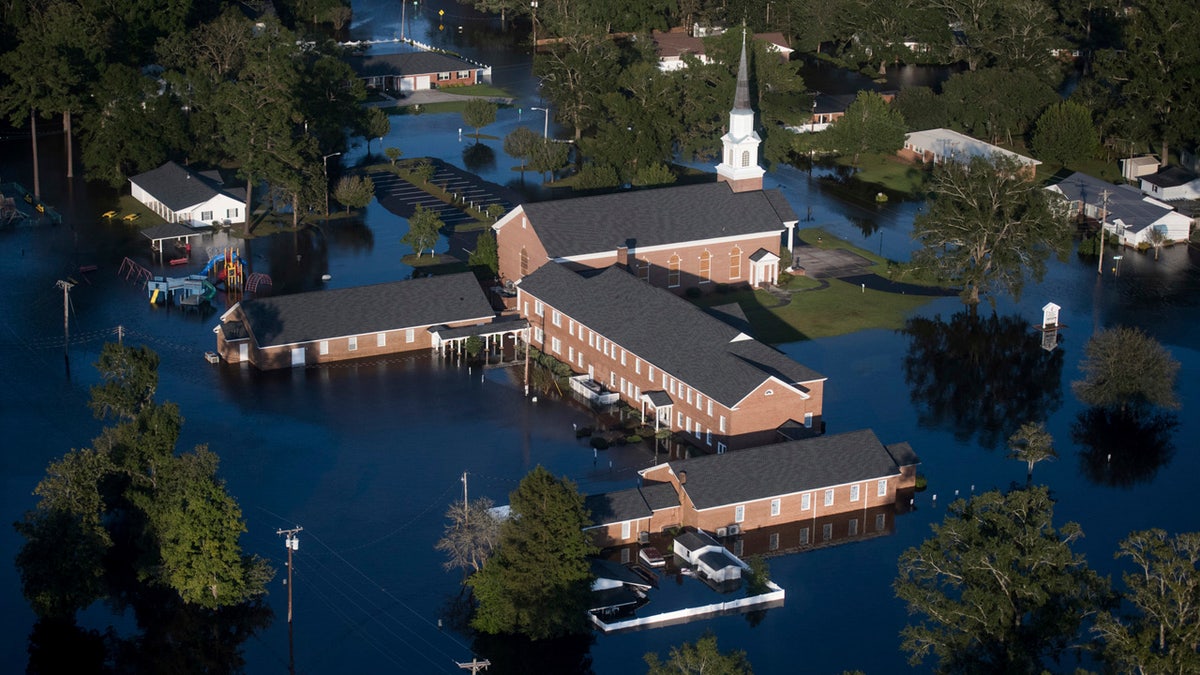In this Monday, Sept. 17, 2018 file photo, floodwaters surround a church and other buildings in Conway, S.C., after Hurricane Florence struck the Carolinas.