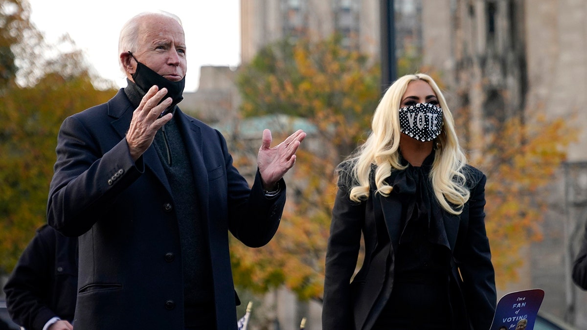 Democratic presidential candidate former Vice President Joe Biden stands with Lady Gaga, right, Monday, Nov. 2, 2020, in Pittsburgh, Pa. 