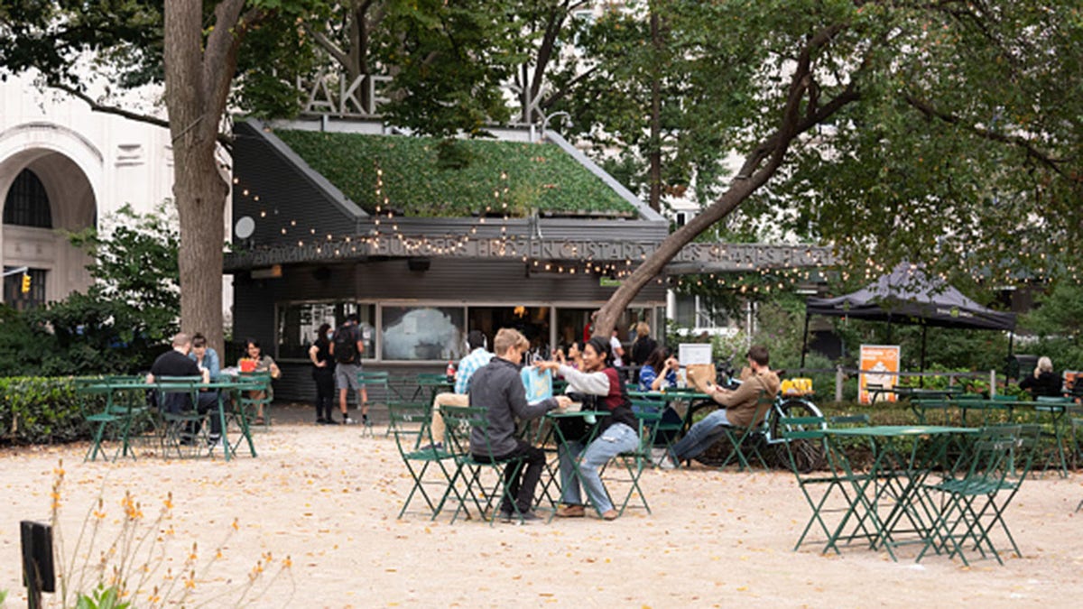 File photo - people dine outside Shake Shack in Madison Square Park in September. (Photo by Noam Galai/Getty Images)