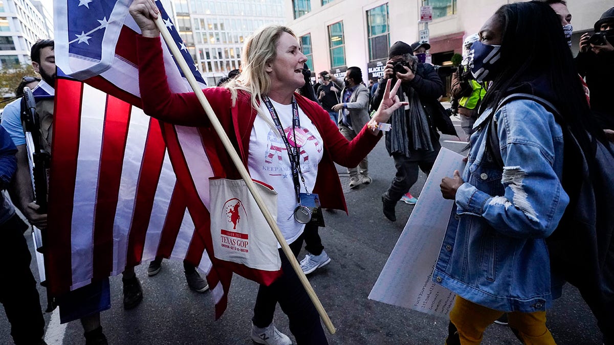 A woman gestures as she argues with a counter-protester. The counter-protester was seen on video running up behind the woman and punching her in the back of the head before running away. (AP Photo/Julio Cortez)