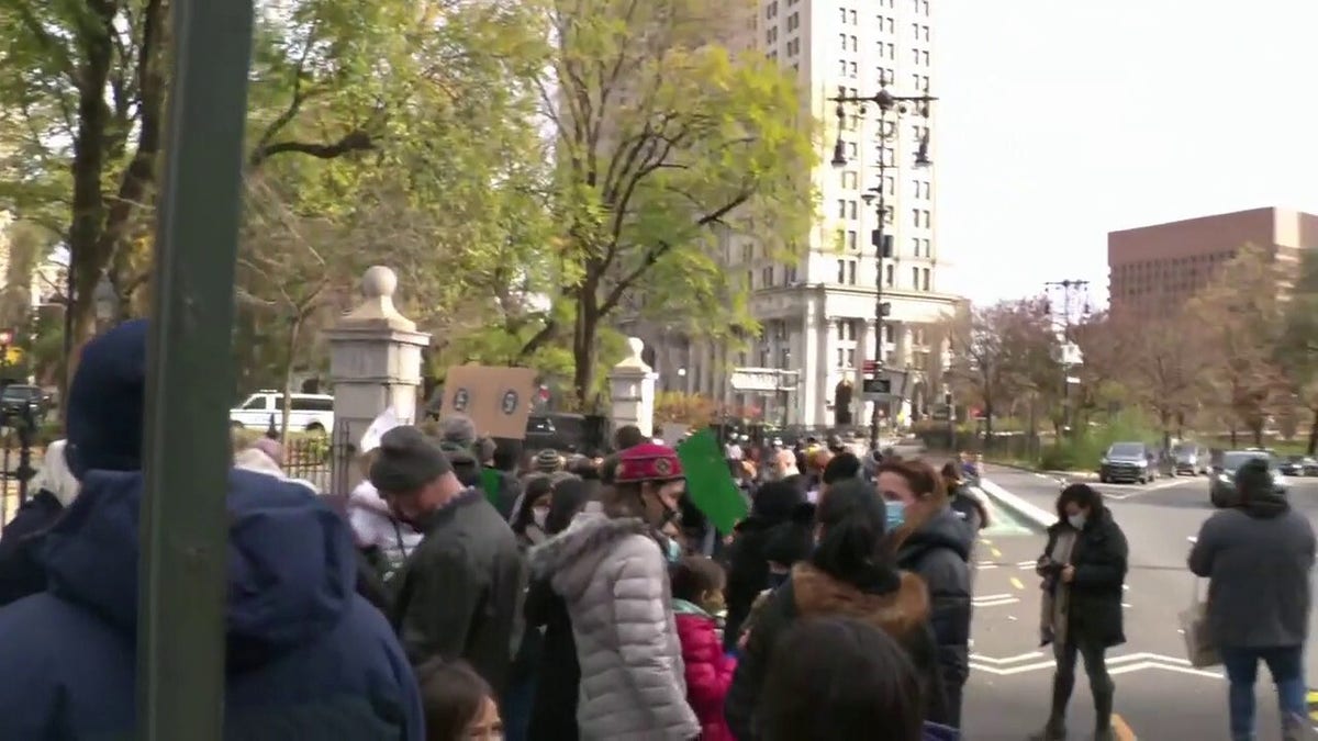 Protesters gather outside City Hall in Manhattan after New York City Mayor Bill de Blasio shut down in-person instruction in public schools.