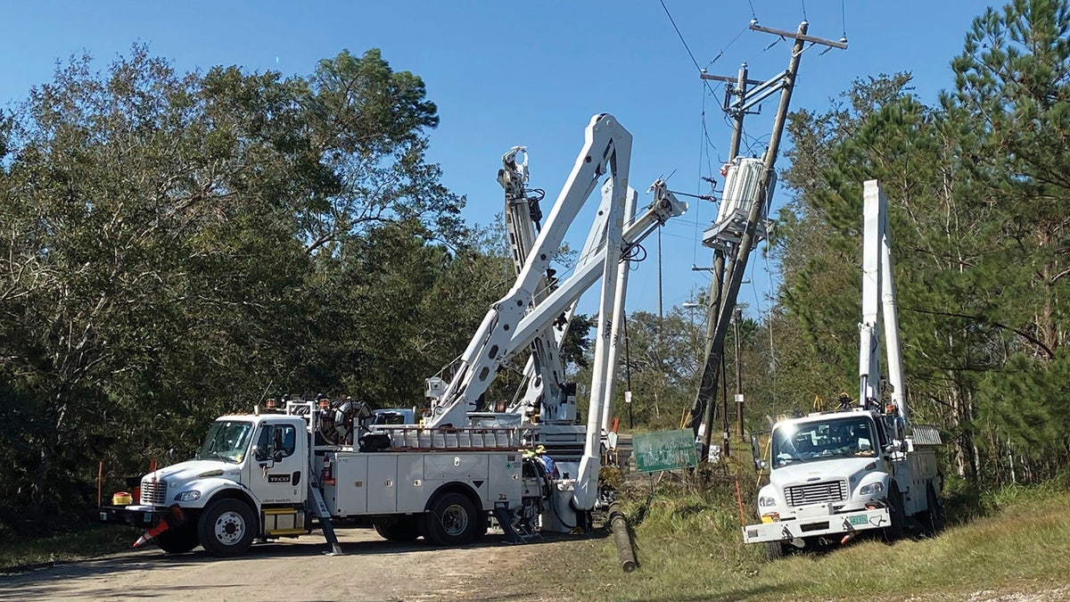 Utility workers repair the power lines at Giani Road in rural Pass Christian, Miss., where thousands of people are without power on Saturday, Oct. 31, 2020, following Hurricane Zeta. 