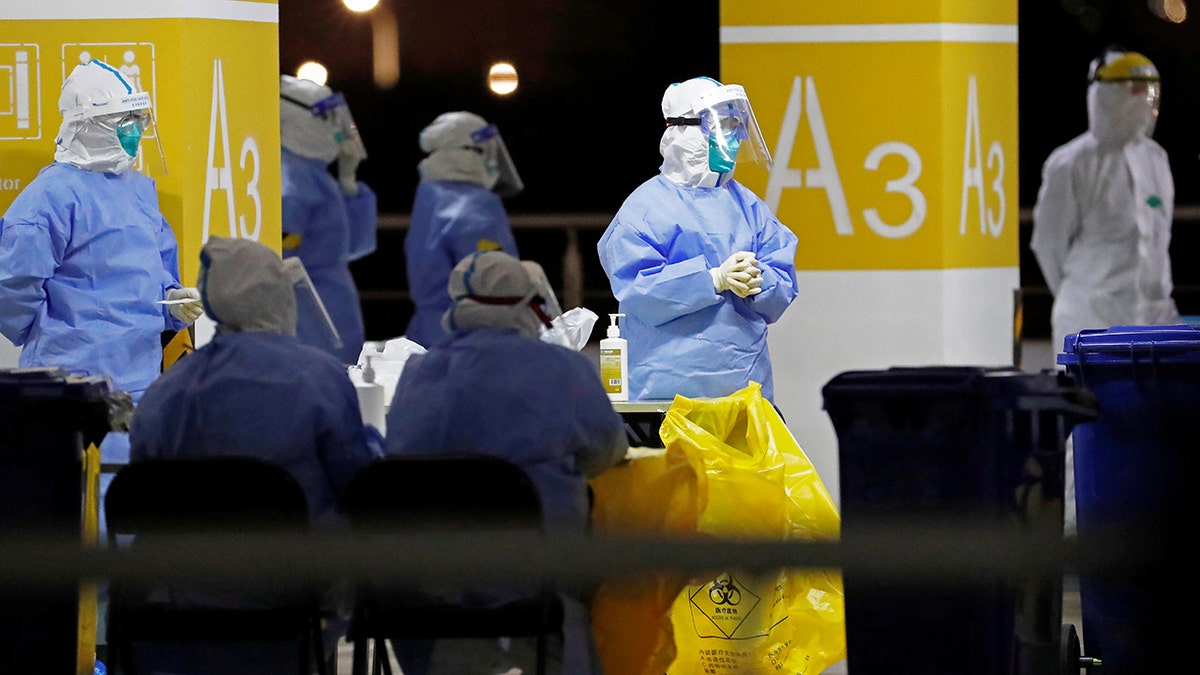 Workers in PPE gear are seen preparing to test high-risk employees of the Shanghai Pudong International Airport following an outbreak among cargo workers.