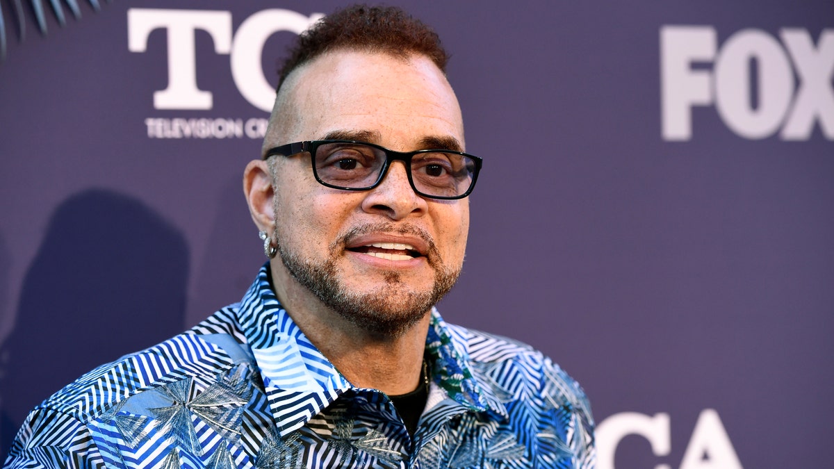 Sinbad poses on a red carpet in 2020