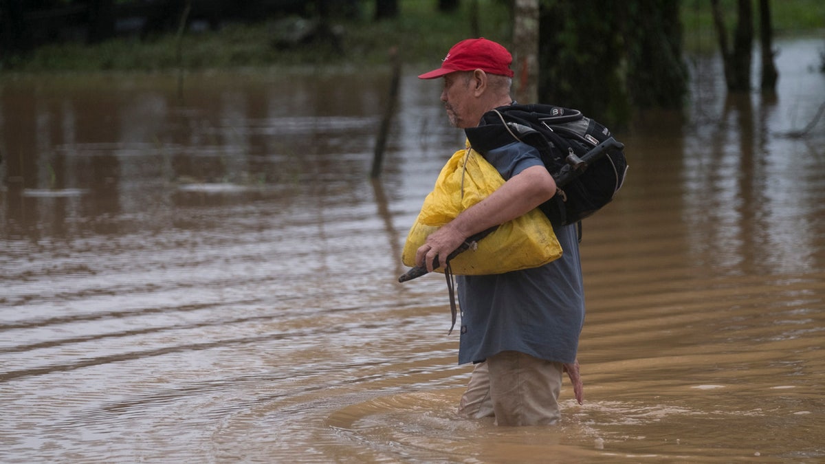 A man walks through a flooded road in Okonwas, Nicaragua, Wednesday, Nov. 4, 2020.