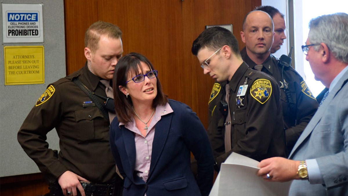 Tina Talbot gives her lawyer Jerome Sabbota a distressed look as Oakland County Sheriff's deputies put her in handcuffs after she is sentenced on April 4, 2019 in Oakland County Circuit Court. (Aileen Wingblad/The Daily Oakland Press via AP)