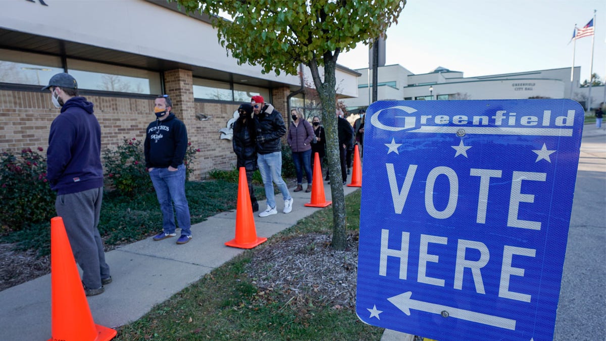 People line up to vote outside the Greenfield Community Center on Election Day, Tuesday, Nov. 3, 2020, in Greenfield, Wisconsin. (AP Photo/Morry Gash)