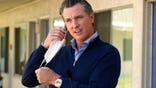 FILE - In this June 30, 2020, file photo, Gov. Gavin Newsom removes his face mask before giving an update during a visit to Pittsburg, Calif. Newsom said in a statement Friday, Nov. 13, that he should not have attended a birthday dinner with a dozen people at the posh French Laundry restaurant last week, saying that he should have set a better example for a virus-fatigued state that is seeing steep increases in coronavirus cases. Newsom’s decision to attend was made as he’s been telling others to not mingle with others outside their households. (AP Photo/Rich Pedroncelli, Pool, File)