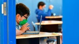 Students work on their laptop computers at St. Joseph Catholic School in La Puente, California on November 16, 2020, where pre-kindergarten to Second Grade students in need of special services returned to the classroom today for in-person instruction. - The campus is the second Catholic school in Los Angeles County to receive a waiver approval to reopen as the coronavirus pandemic rages on.  The US surpassed 11 million coronavirus cases Sunday, adding one million new cases in less than a week, according to a tally by Johns Hopkins University. (Photo by Frederic J. BROWN / AFP) (Photo by FREDERIC J. BROWN/AFP via Getty Images)