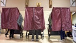 Voters occupy booths at St. Maria Goretti Church, where five voting precincts are located, as polls open for Election Day in New Orleans, Tuesday, Nov. 3, 2020. (Max Becherer/The Advocate via AP)