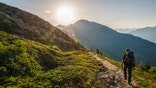 Venetberg, Austria - August 02 2017: Single hiker in the early morning at sunrise on a trekking path in the Lechtaler Alps