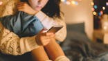 Girl texting on smartphone at home (iStock)