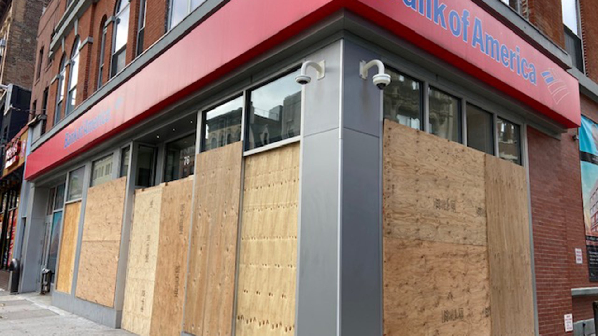 The Bank of America branch on New York City's Court Street, is one of the businesses targeted in clashes last week. It is now fully boarded up.