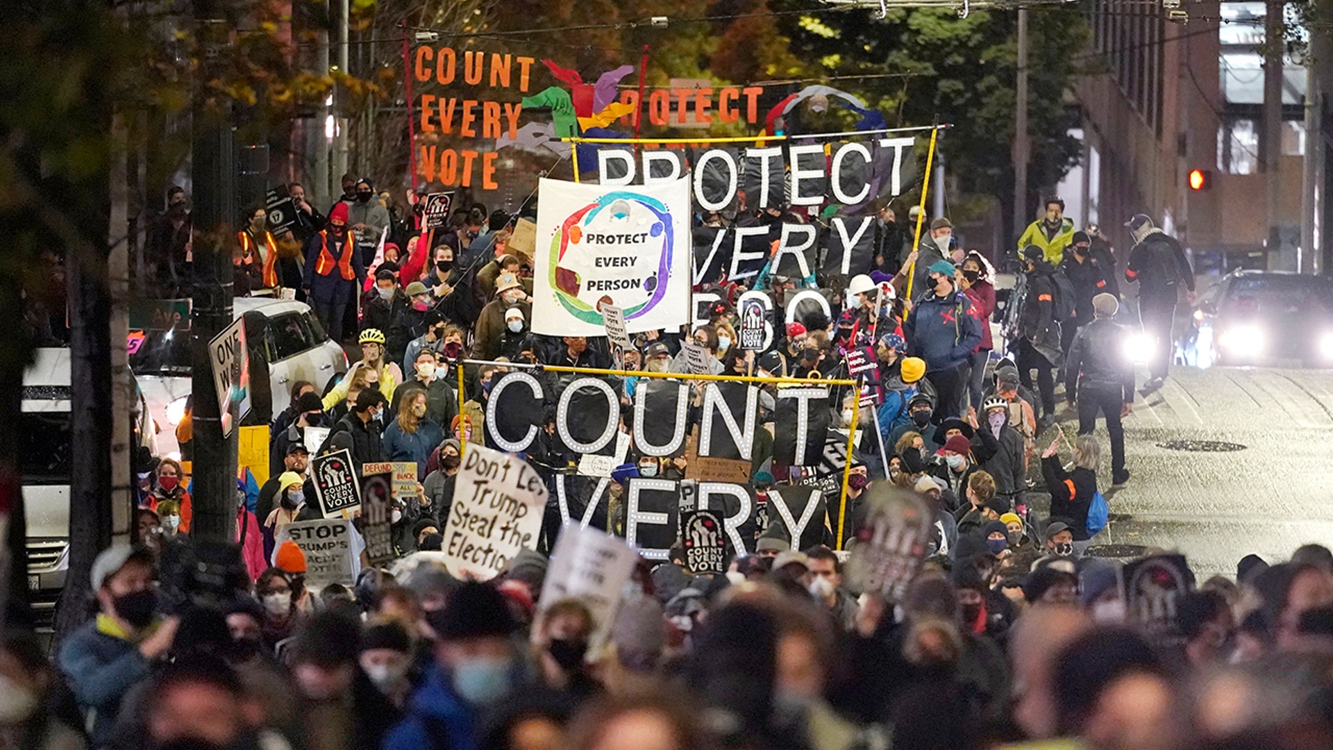 Protesters representing Black Lives Matter and Protect the Results march Wednesday evening, Nov. 4, 2020, in Seattle.