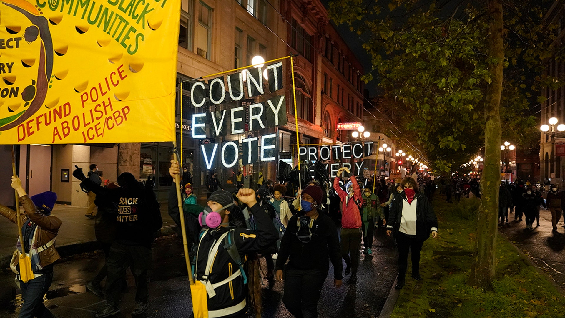 People take part in a protest for Black Lives Matter and to protect the vote after the Nov. 3 elections, Wednesday, Nov. 4, 2020, in Seattle. 
