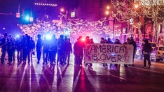 Protesters in Minneapolis carry ‘America is Over’ banner; 14 arrested after setting off fireworks, police say
