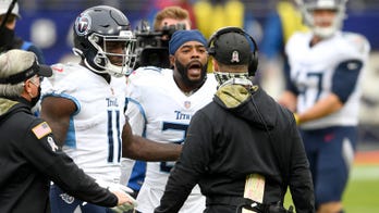 Ravens' John Harbaugh exchanges words with Titans' Malcolm Butler, Mike Vrabel after pregame midfield display