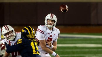 No. 13 Wisconsin routs Michigan 49-11 in 1st game in 3 weeks