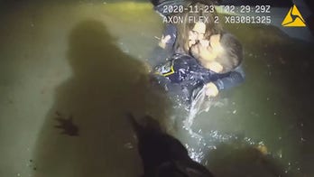 Ohio police rescue woman trapped in sinking minivan after crashing in river, video shows