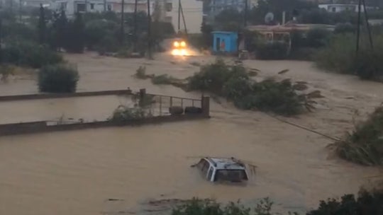 Flooding in Greece sweeps cars into sea, sends people to rooftops