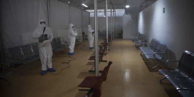 <br>
Sanitation technicians disinfect a tent used to test patients for COVID-19 at the Ajusco Medio General Hospital in Mexico City, Thursday, Nov. 19, 2020. (AP Photo/Marco Ugarte)