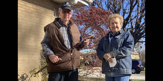 <br>
Dan Donovan, joined by his wife, Barbara, holds the antique shillelagh he used to chase burglars from the couple's Niles home even hitting one of the men in the back of the head, Tuesday, Nov. 17, 2020 in Niles, Ill. Donovan, an 81-year-old former Marine from suburban Chicago used his grandfather's antique Irish walking stick to chase off three burglars and deliver one a thump in the head for his trouble.(Jennifer Johnson/Chicago Tribune via AP)