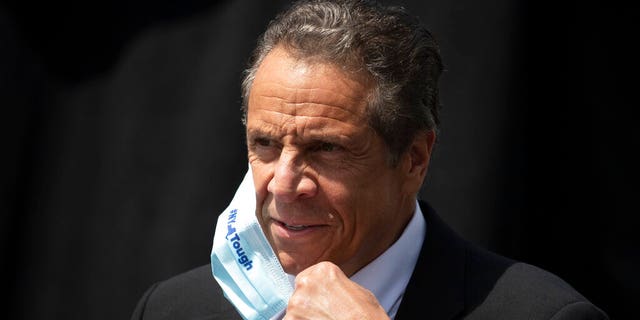 In this June 15 photo, New York Gov. Cuomo removes a mask as he holds a news conference in Tarrytown, N.Y.  (AP Photo/Mark Lennihan, File)