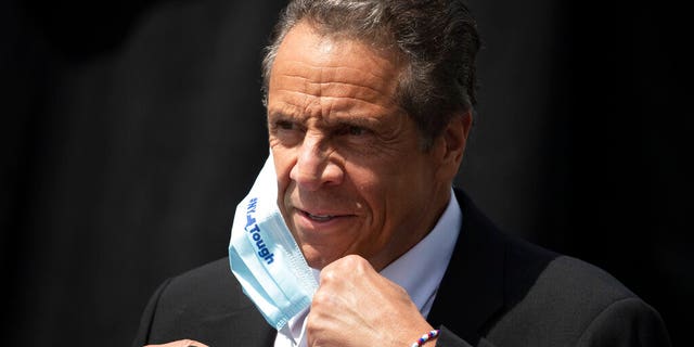 In this June 15 photo, New York Gov. Cuomo removes a mask as he holds a news conference in Tarrytown, N.Y.  (AP Photo/Mark Lennihan, File)