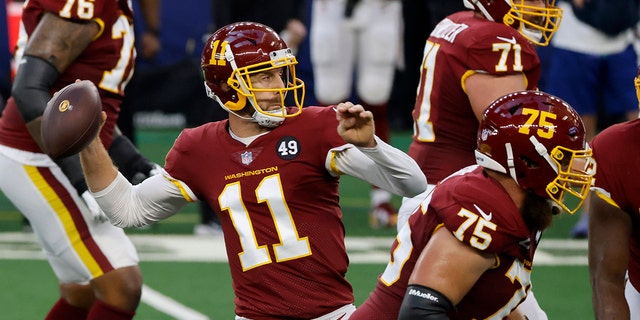 Washington Football Team quarterback Alex Smith (11) throws a pass from the pocket as Brandon Scherff (75) and Wes Schweitzer (71) defend against pressure in the first half of an NFL football game against the Dallas Cowboys in Arlington, Texas, Thursday, Nov. 26, 2020.