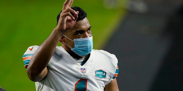 Miami Dolphins quarterback Tua Tagovailoa (1) gesture as he leaves the field at the end of an NFL football game against the Los Angeles Chargers, Sunday, Nov. 15, 2020, in Miami Gardens, Fla. The Dolphins defeated the Chargers 29-21. (AP Photo/Lynne Sladky)