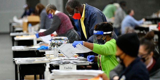 Election workers in Fulton County began working through a recount of ballots Saturday, Nov. 14, 2020 in Atlanta. (Associated Press)