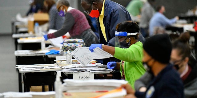 Election workers in Fulton County began working through a recount of ballots Saturday, Nov. 14, 2020 in Atlanta. (Associated Press)