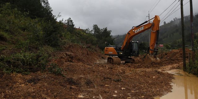 A backhoe clears a road blocked by debris brought on by a landslide in the aftermath of Hurricane Eta, in Purulha, northern Guatemala Nov. 6. As the remnants of Eta moved back over Caribbean waters, governments in Central America worked to tally the displaced and dead, and recover bodies from landslides and flooding that claimed dozens of lives from Guatemala to Panama. (AP Photo/Moises Castillo)