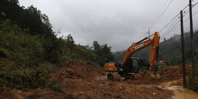 A backhoe clears a road blocked by debris brought on by a landslide in the aftermath of Hurricane Eta, in Purulha, northern Guatemala Nov. 6. As the remnants of Eta moved back over Caribbean waters, governments in Central America worked to tally the displaced and dead, and recover bodies from landslides and flooding that claimed dozens of lives from Guatemala to Panama. (AP Photo/Moises Castillo)