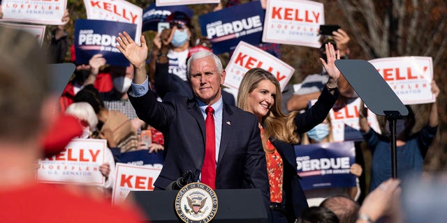 Vice President Mike Pence and Sen. Kelly Loeffler wave to the crowd during a Defend the Majority Rally, Friday, Nov. 20, 2020 in Canton, Ga. (Associated Press)