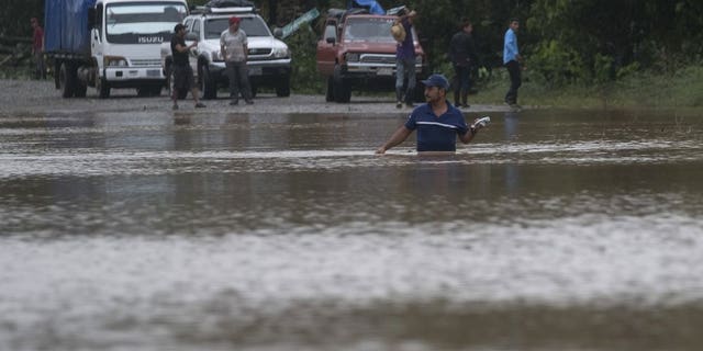 A man walks through a flooded road in Okonwas, Nicaragua, Wednesday, Nov. 4, 2020. Eta weakened from the Category 4 hurricane to a tropical storm after lashing Nicaragua's Caribbean coast for much of Tuesday, its floodwaters isolating already remote communities and setting off deadly landslides. (AP Photo/Carlos Herrera)