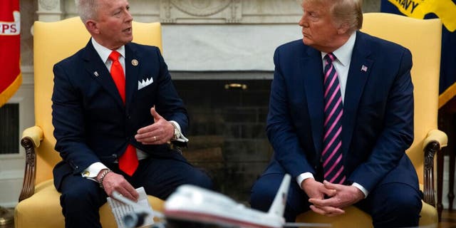 President Donald Trump meets with Rep. Jeff Van Drew, D-N.J., who is planning to switch his party affiliation, in the Oval Office of the White House, Thursday, Dec. 19, 2019, in Washington. (AP Photo/ Evan Vucci)
