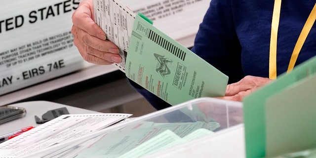 Election workers sort ballots Wednesday, Oct. 21, 2020, at the Maricopa County Recorder's Office in Phoenix.  Despite massive turnout for early voting, elections in Arizona are going pretty smoothly.  By the following Tuesday, Maricopa County had processed more than 1.2 million ballots, surpassing the total number of early ballots cast in 2016.