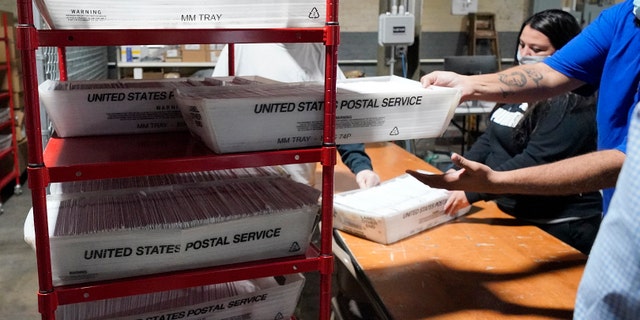 Allegheny County mail services workers, process some of the mail-in and absentee ballots received at the Allegheny County Election Division's Elections warehouse in Pittsburgh, Thursday, Oct. 29, 2020. (AP Photo/Gene J. Puskar)