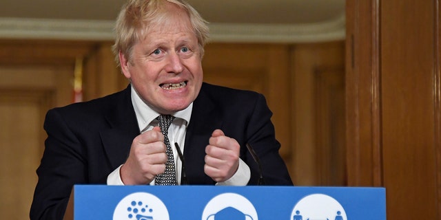 Britain's Prime Minister Boris Johnson gestures as he speaks during a press conference in 10 Downing Street, London, Saturday, Oct. 31, 2020 where he is expected to announce new restrictions to help combat a coronavirus surge. (AP Photo/Alberto Pezzali, Pool)