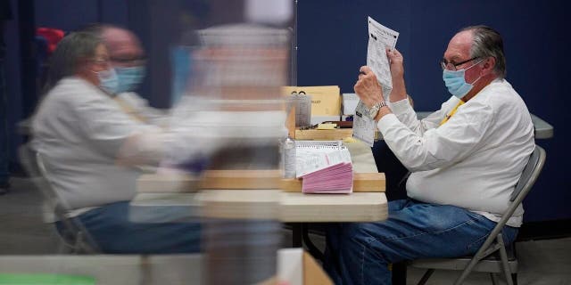 Was my vote counted? A state-by-state guide to tracking your absentee ballot 2 County employees process mail-in ballots at a Clark County election department facility Saturday, Oct. 31, 2020, in Las Vegas. (AP Photo/John Locher)