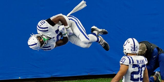 Indianapolis Colts running back Nyheim Hines (21) performs a somersault after a 22-yard run for a touchdown during the first half of an NFL football game against the Detroit Lions, Sunday, Nov. 1, 2020, in Detroit. (AP Photo/Carlos Osorio)