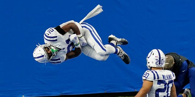 Indianapolis Colts running back Nyheim Hines (21) performs a somersault after a 22-yard run for a touchdown during the first half of an NFL football game against the Detroit Lions, Sunday, Nov. 1, 2020, in Detroit. (AP Photo/Carlos Osorio)