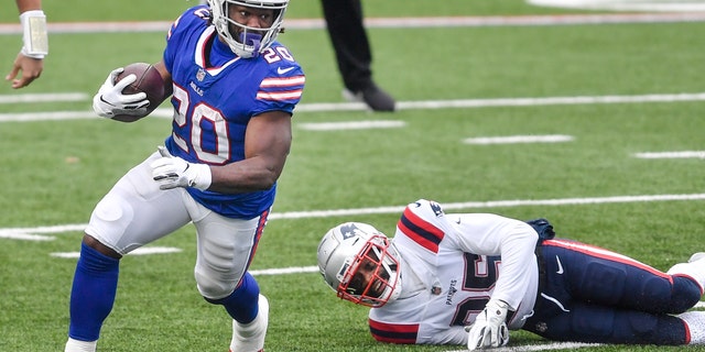 Buffalo Bills' Zack Moss (20) rushes past New England Patriots' Terrence Brooks (25) during the first half of an NFL football game Sunday, Nov. 1, 2020, in Orchard Park, N.Y. (AP Photo/Adrian Kraus)